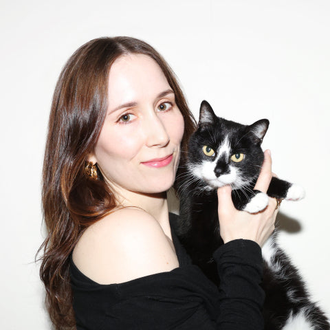 Petlibro PETLIBRO cat pet held by woman in black top, close-up portrait on white background, not a litter box scene